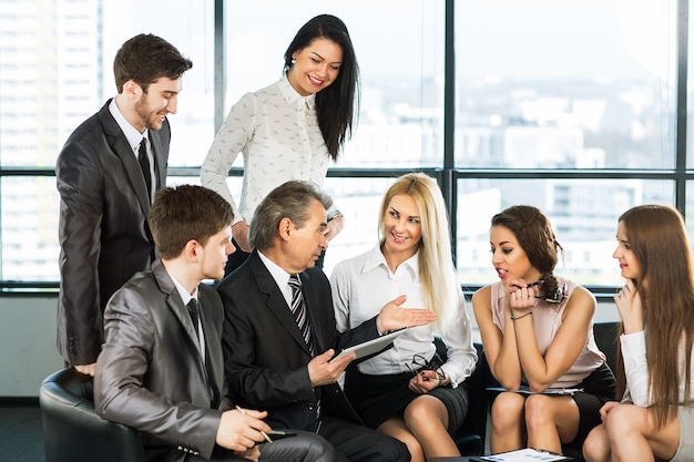 A group of businessmen discussing the policy of the company t