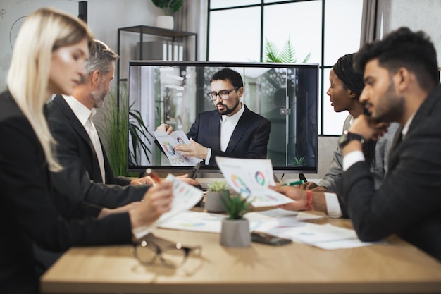 Group Of Businesspeople Having Video Conference In Boardroom