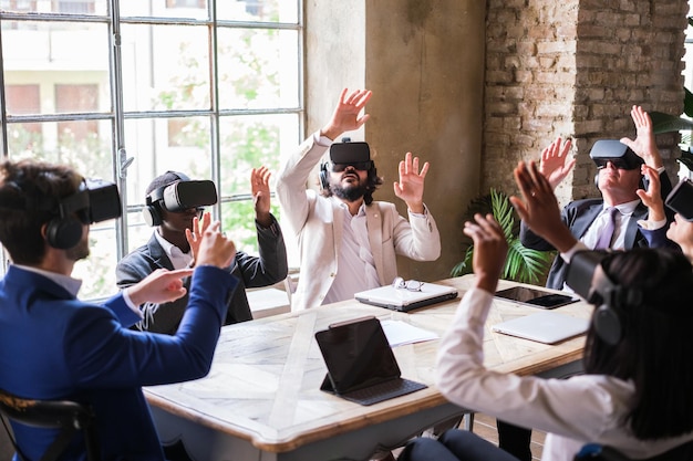 Group of businesspeople testing virtual reality in a coworking space