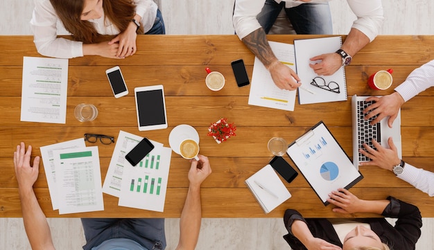 Group of busy business people working in office, top view