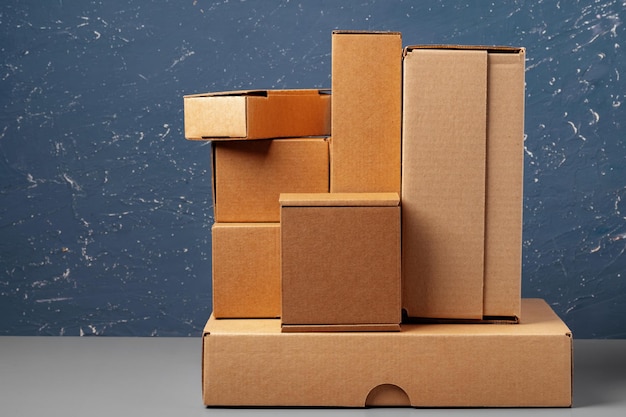 Group of cardboard boxes against blue background