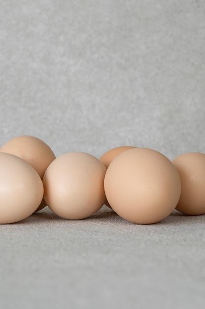 Group of chicken eggs on a gray background with copy space