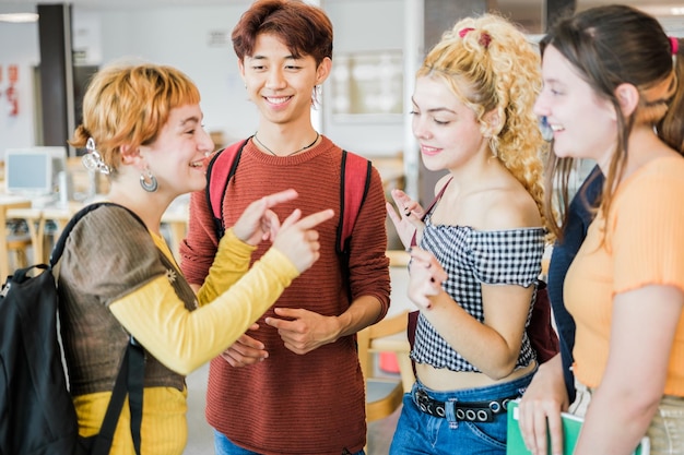 Group of classmates exchanging opinions inside the university library