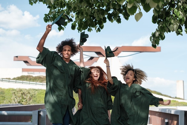 Group of college students celebrating graduation together Concept studies education training