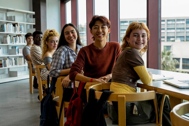 Group of college students studying together in a library