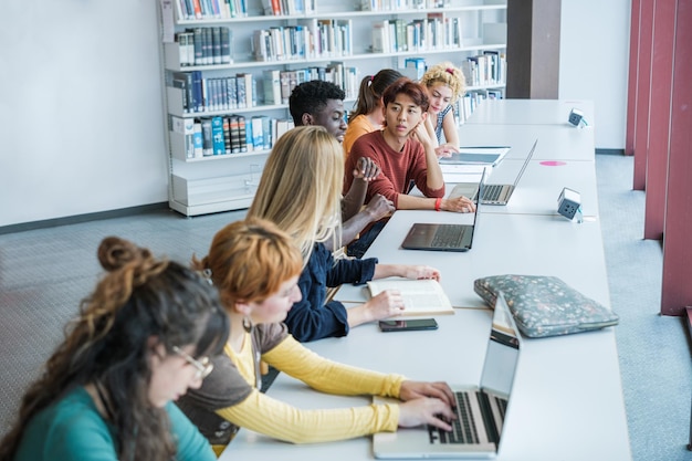 Group of college students studying at university focus on young asian man