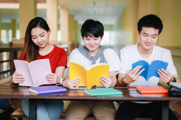 Group of college students or university students read books together