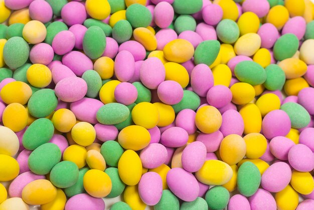 Group of colorful peanuts in glaze. Top view.