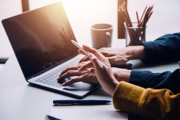 Group of confident business people point to graphs and charts to analyze market data balance sheet account net profit to plan new sales strategies to increase production capacity