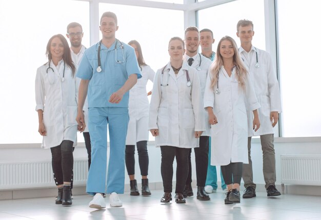 Group of confident doctors striding in the hospital corridor