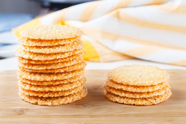 Group of cookies with sesame seeds on wooden board