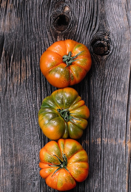 A group of Costoluto tomatos on a wooden background