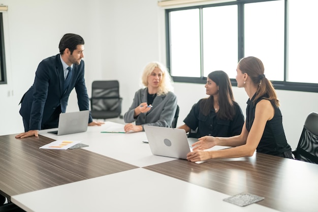 Group of coworkers in formal wear sitting at table in conference room Business meeting team in office