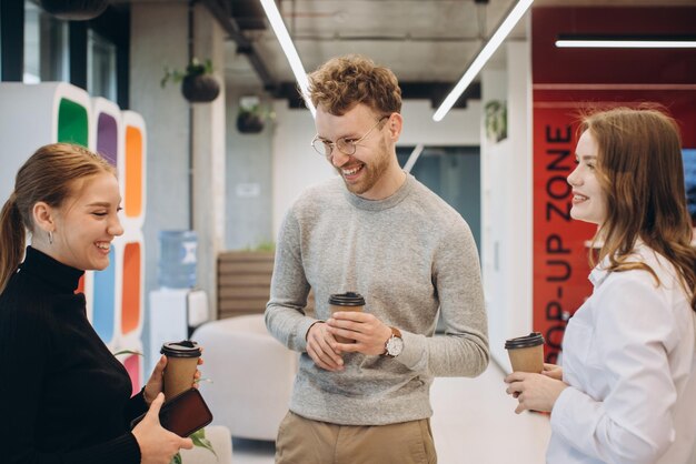 Group of coworkers taking a coffee break at the office