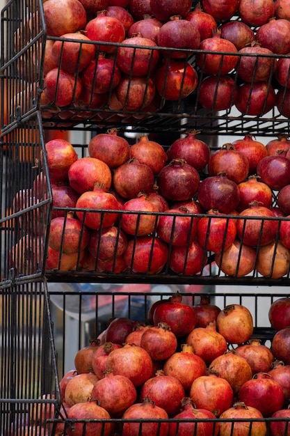 Group of cut red pomegranate fruit on display at market