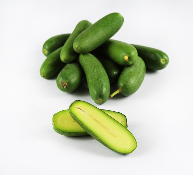 Group of cut and whole seedless mini avocado or cocktail avocado isolated on white background