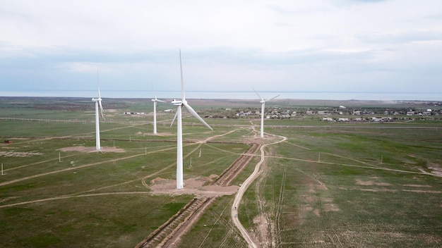 A group of cyclists rides along the windmills