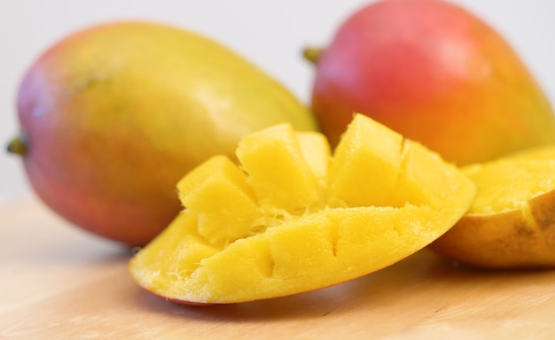 Group of delicious mango tropical fruit on wood board