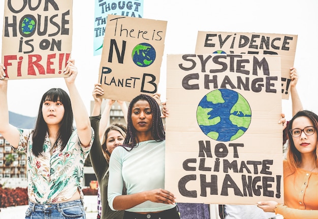 Group of demonstrators on road, young people from different culture and race fight for climate change. Global warming and environment concept