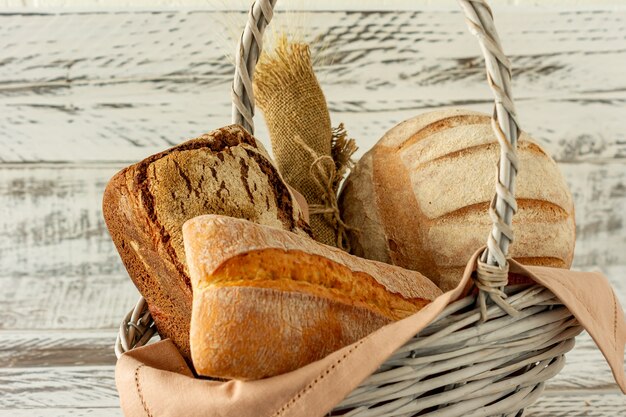 Group of different bread's type on wooden table.