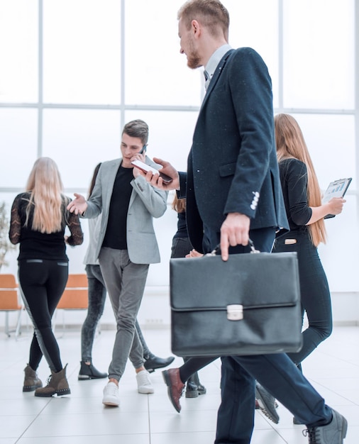 Group of different business people passing in the office lobby