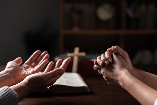 Group of different women praying together Christians and Bible study concept