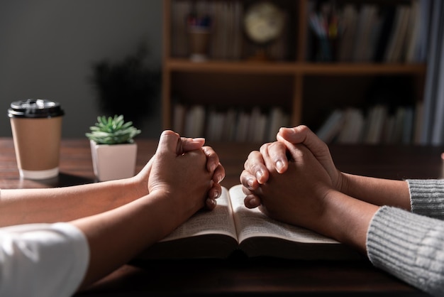 Group of different women praying together Christians and Bible study concept