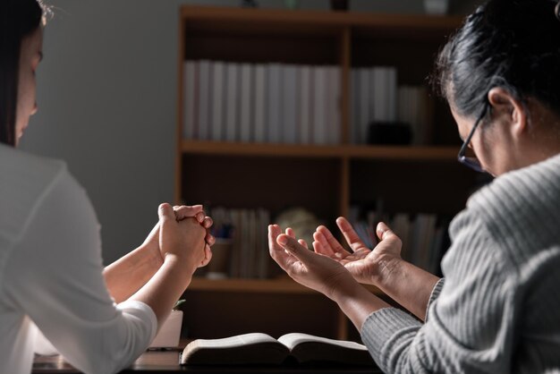 Group of different women praying together Christians and Bible study concept