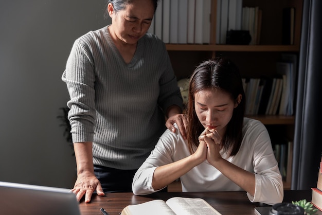 Group of different women praying together Christians and Bible study concept