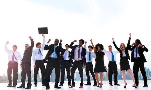 Group of diverse business people with raised arms