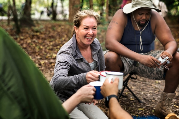 Group of diverse friends camping in the forest