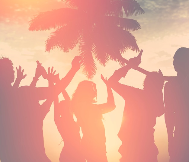 A group of diverse people dancing at the beach