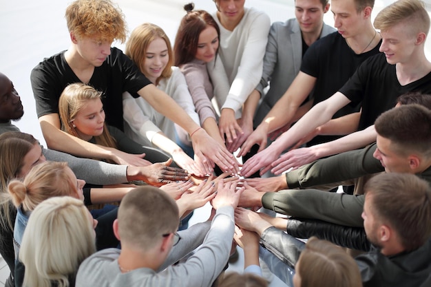 Group of diverse people joining their hands in a circle