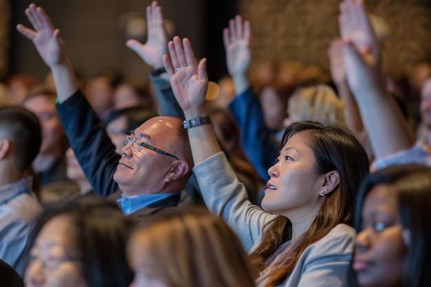 group of diverse people raising their hands to ask a question