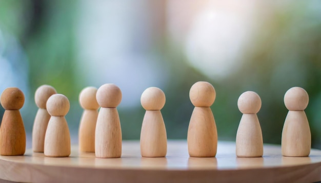 Group of diverse wooden figurines in a line symbolizing unity teamwork and community in social ga