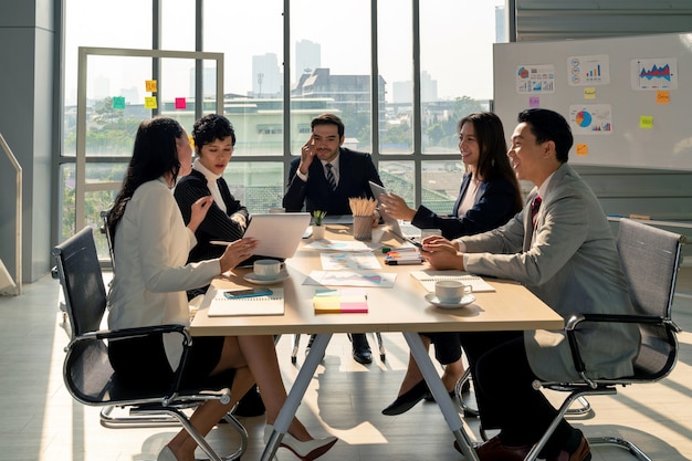 Group of diversity business man and woman planning strategy analysis from financial document report with positive mood in modern meeting conference room