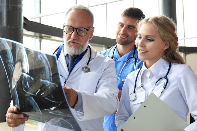 Group of doctors checking x-rays in a hospital.