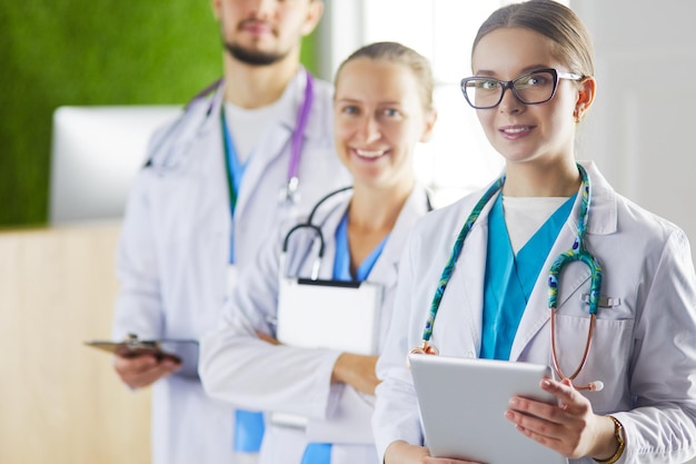 Group of doctors and nurses standing in the hospital room