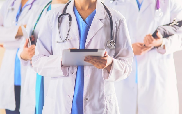 Group of doctors and nurses standing in the hospital room