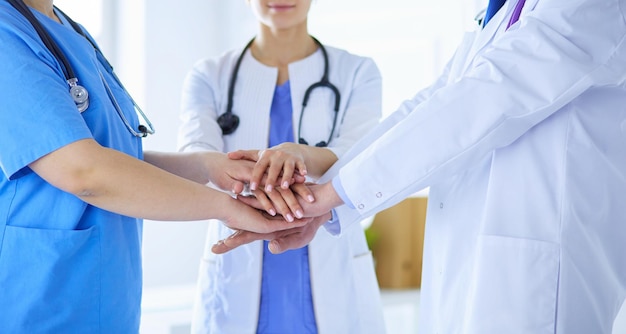 Group of doctors putting their hands together Closeup