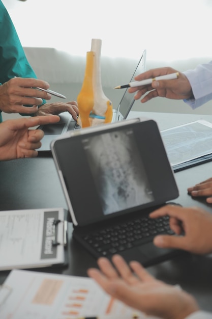 Group of doctors reading a document in meeting room at hospital