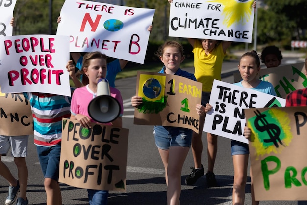 Photo group of elementary school pupils walking on a protest march