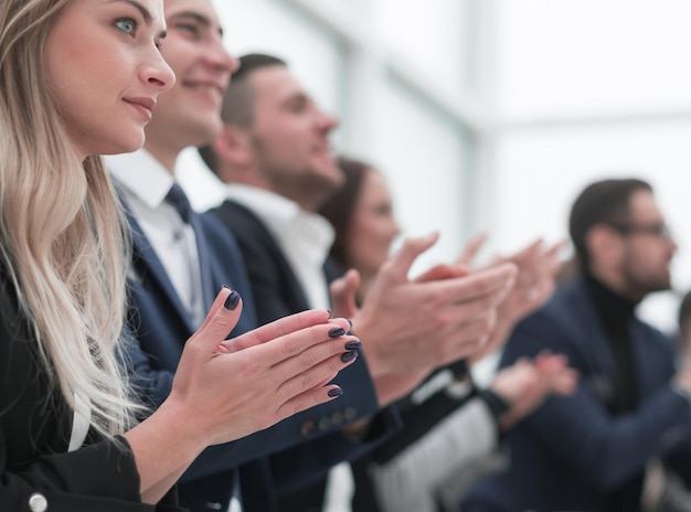 Group of employees applauds during a business meeting