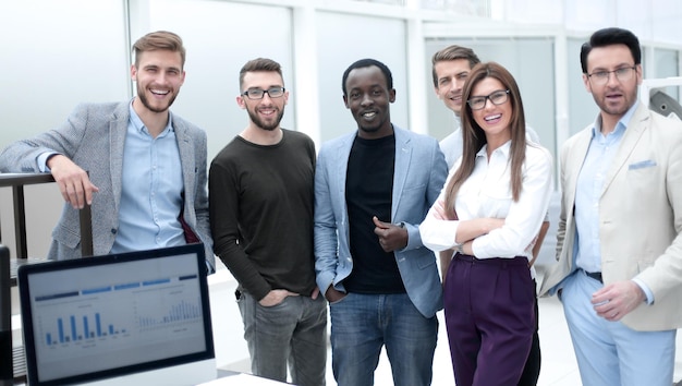 Group of employees standing in the office