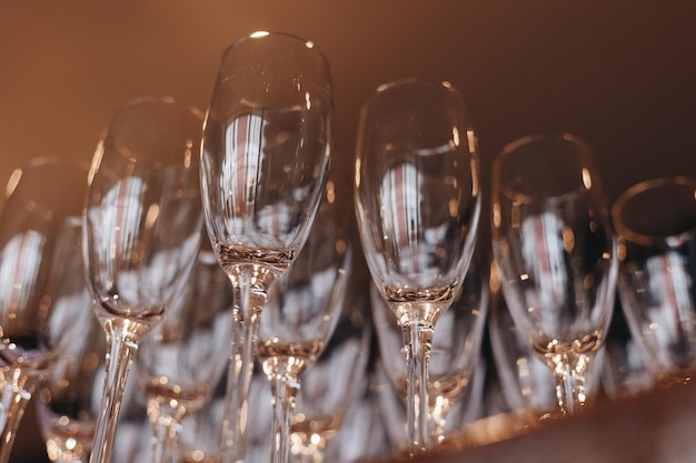 Group of empty and transparent champagne glasses in a restaurant Clean glasses on a table prepared by the bartender for champagne Catering for the event preparation empty glasses for drink