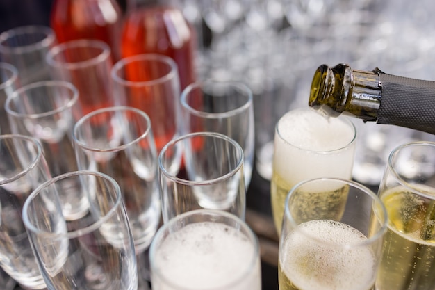 Group of empty and transparent champagne glasses in a restaurant. Clean glasses on a table prepared by the bartender for champagne.