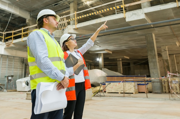 Group of engineers, builders, architects on the building site