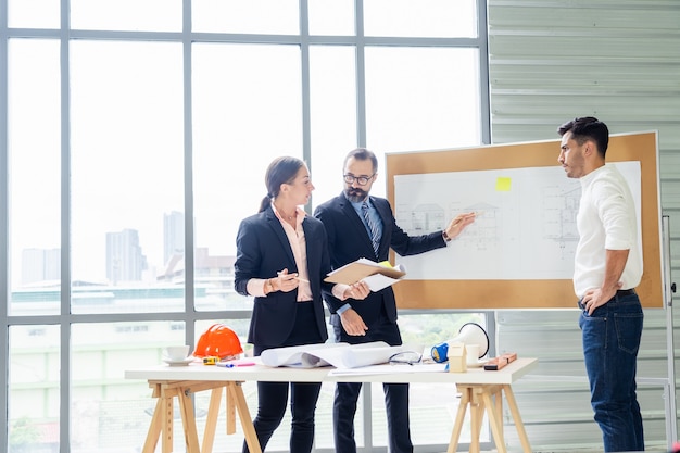 Group of engineers discussing business plan together