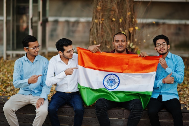 Group of four south asian indian male with India flag.