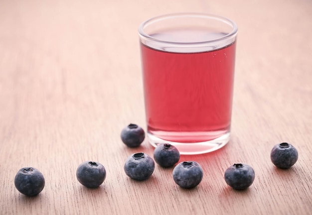 Group of fresh blueberries with juice in a glass